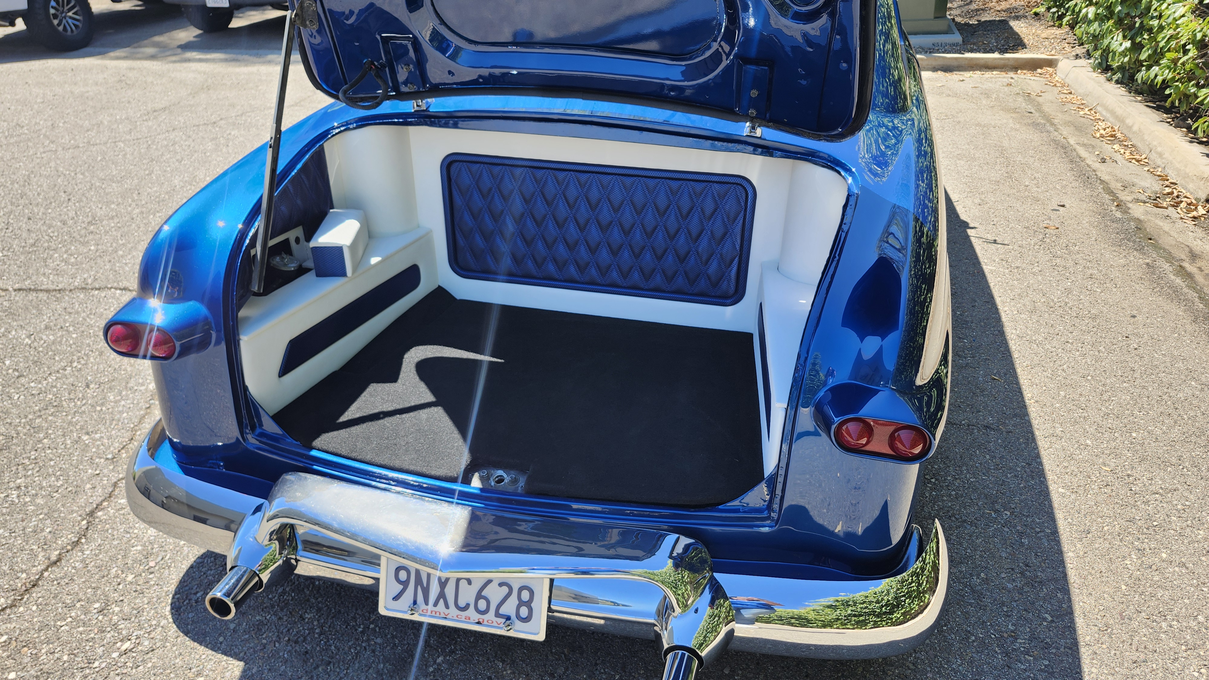 Candy blue classic car trunk with custom audio amp rack and diamond-stitch upholstery, Escondido